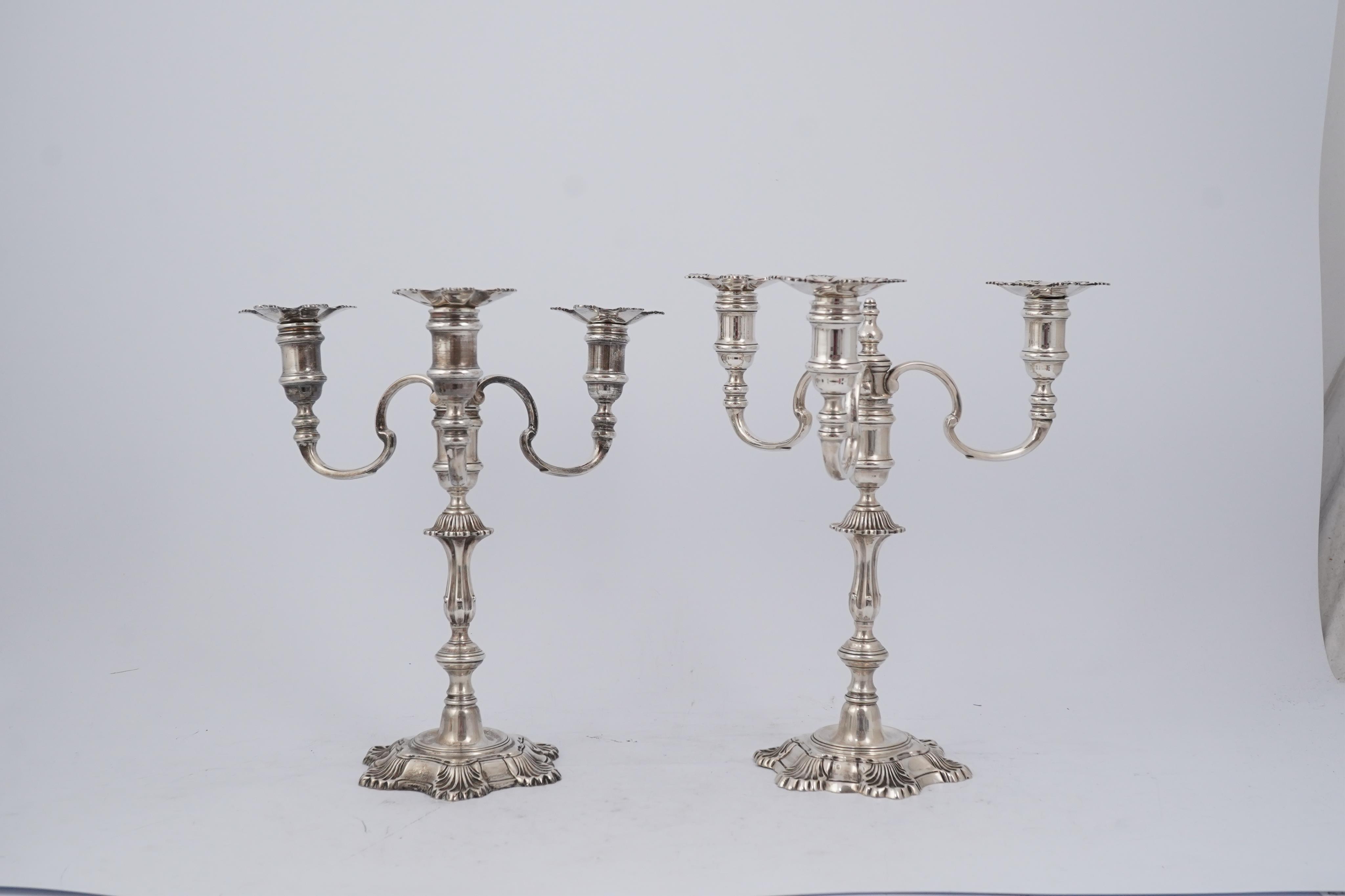 A pair of Elizabeth II cast silver three branch, three light candelabra, by J.B. Chatterley & Sons Ltd